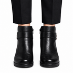Black ankle boots worn by model