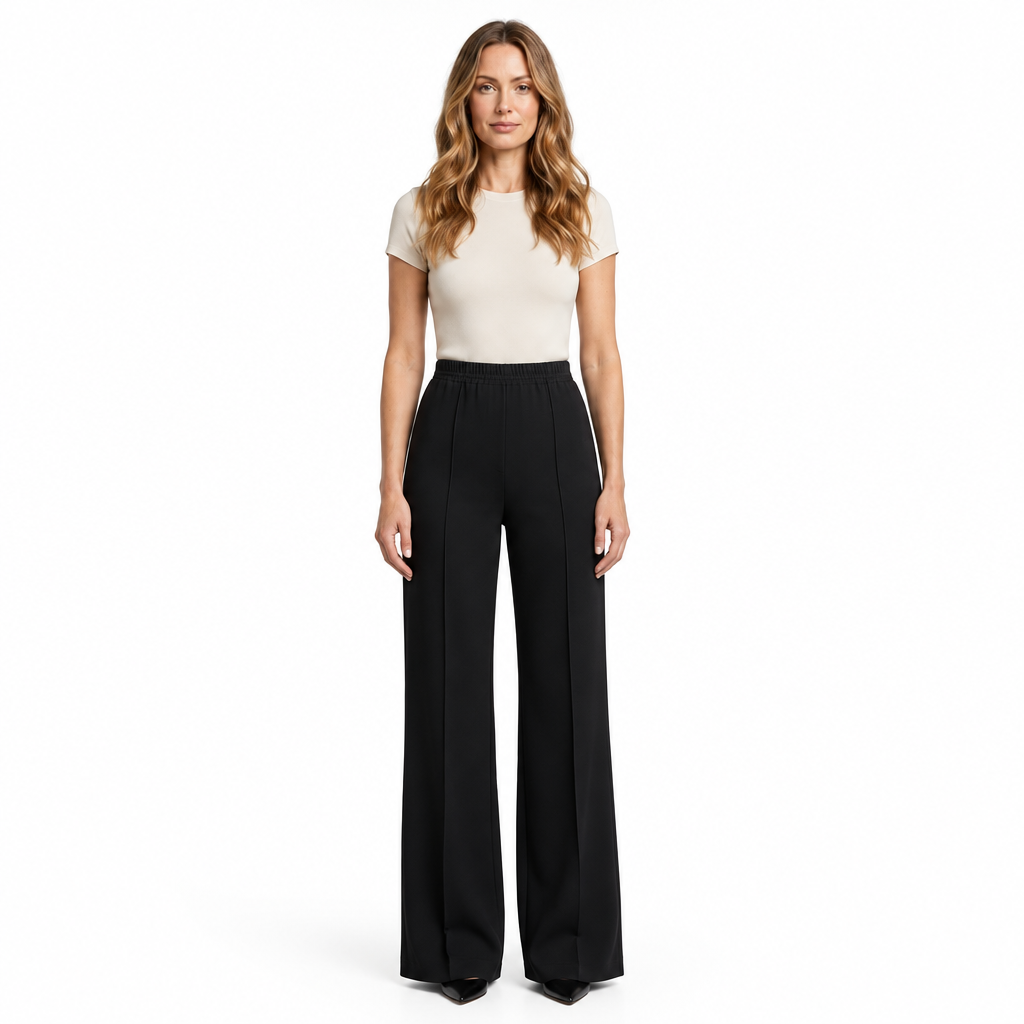 Woman modelling black wide-leg trousers on a white background