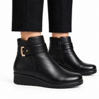 Black ankle boots on model, side view