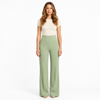 Woman modelling mint green wide-leg trousers on a white background