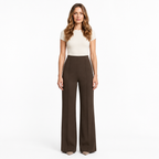 Woman modelling brown wide-leg trousers on a white background
